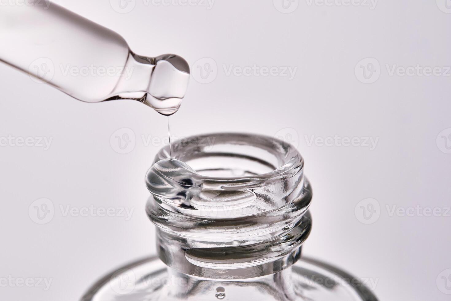 Close-up of a cosmetic bottle with a pipette showing the texture of the serum. photo