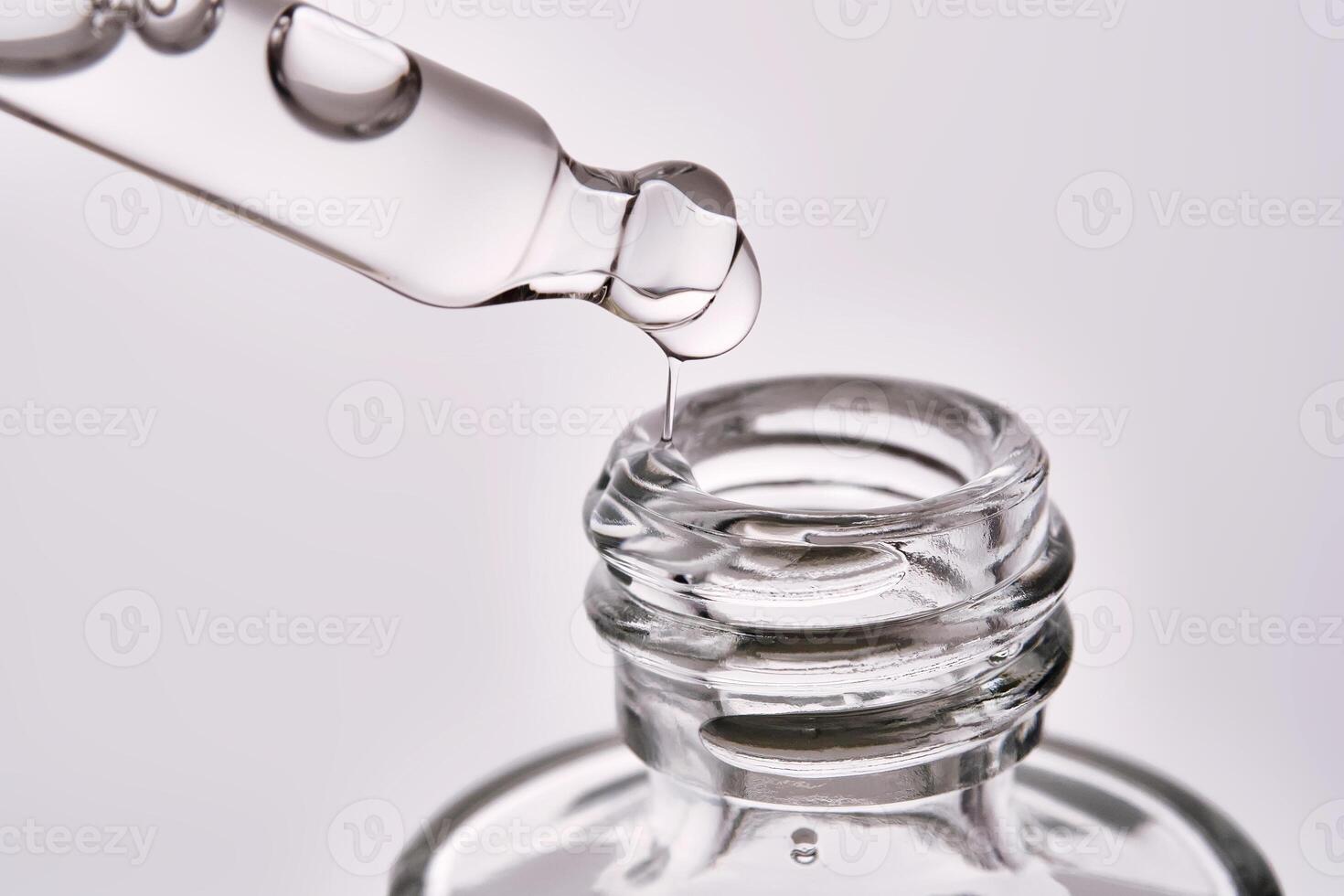 Close-up of a cosmetic bottle with a pipette showing the texture of the serum. photo