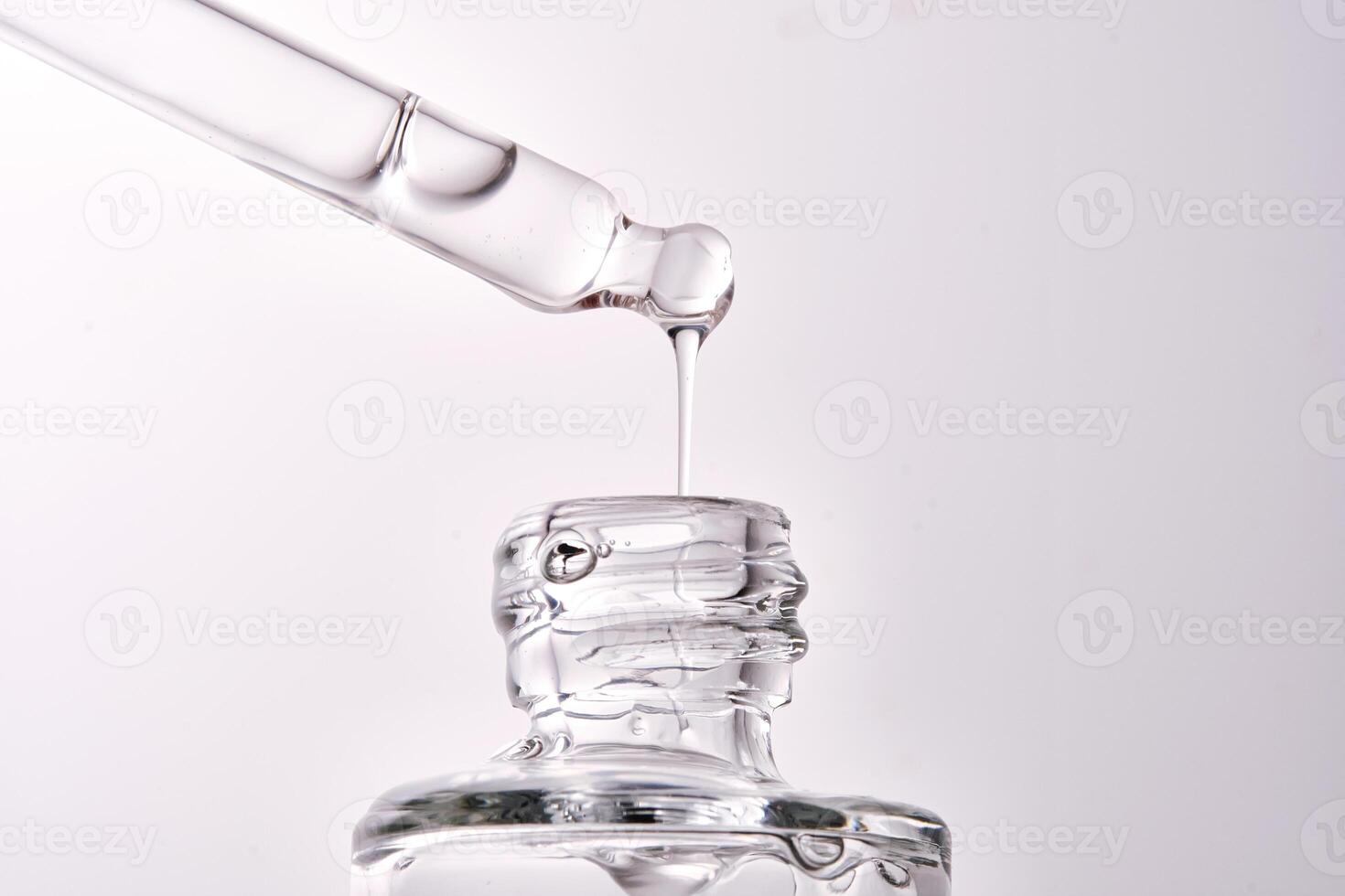 Close-up of a cosmetic bottle with a pipette showing the texture of the serum. photo