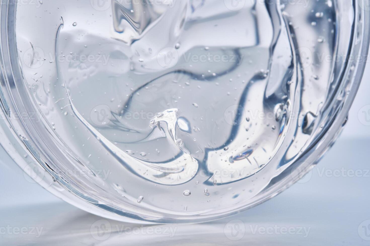 Texture of the gel in the jar. Hair gel or hyaluronic gel for the face. photo