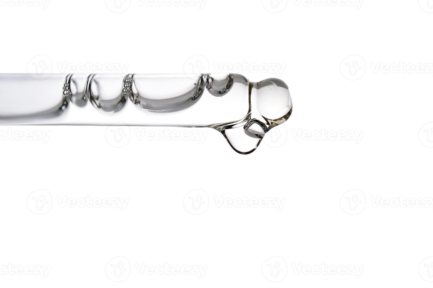 Dropper pipette with delicious serum with bubbles close-up. photo