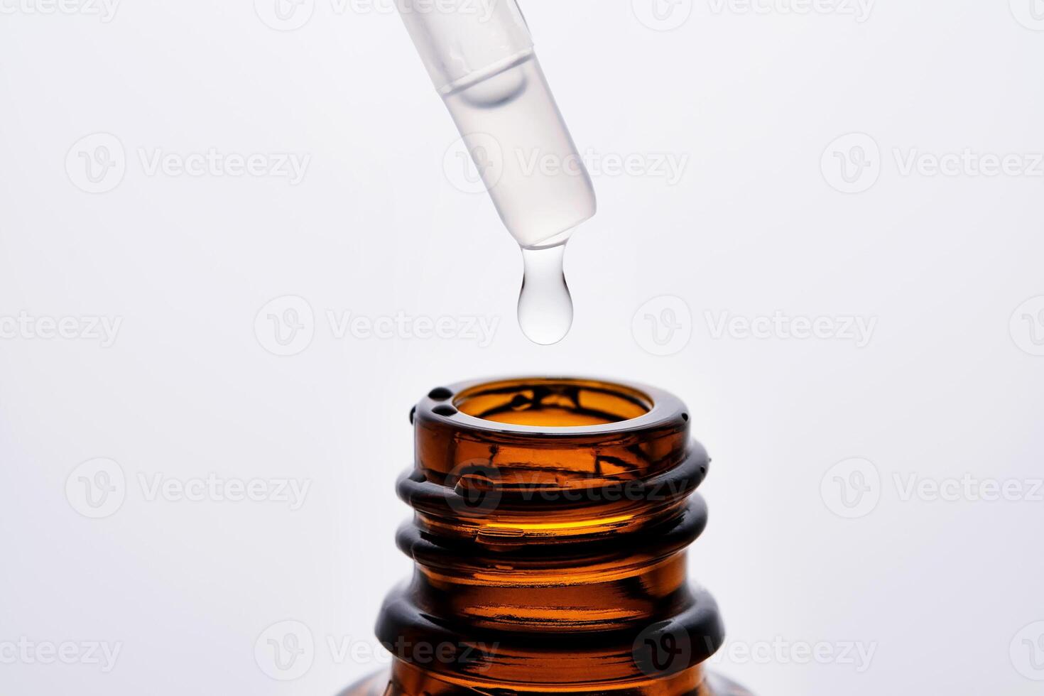Close-up of a brown cosmetic bottle with a pipette. photo