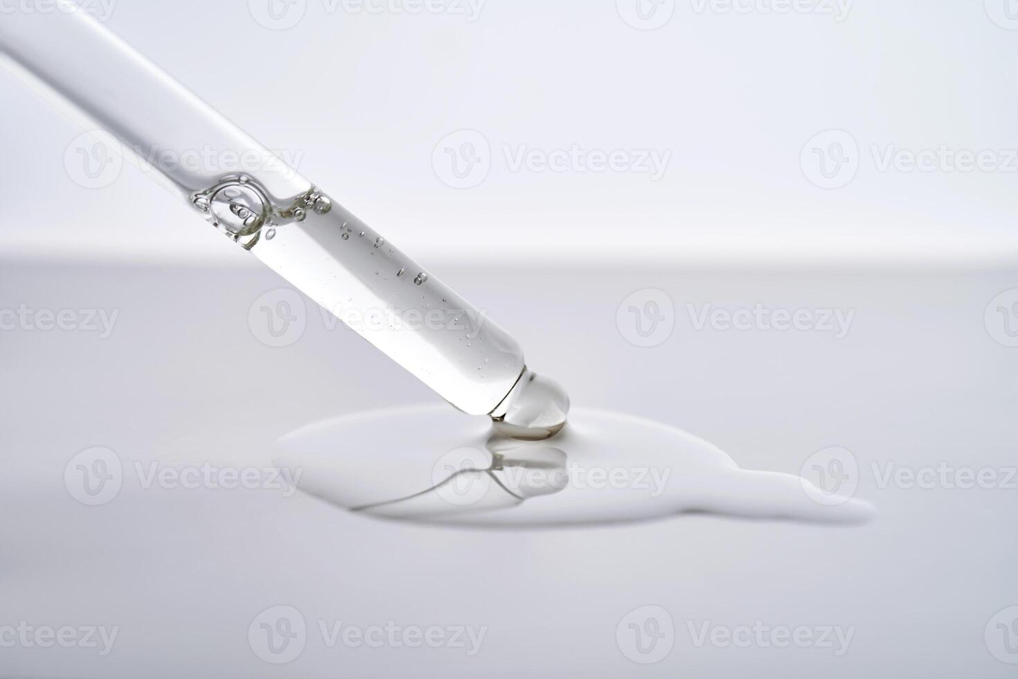 Dropper pipette with delicious serum with drop close-up. photo