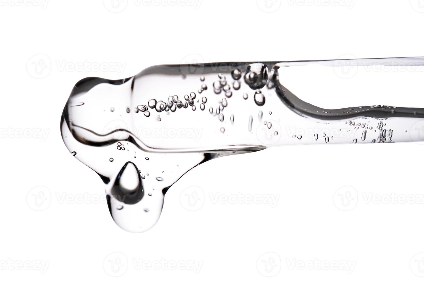 Dropper pipette with delicious serum with bubbles close-up. photo
