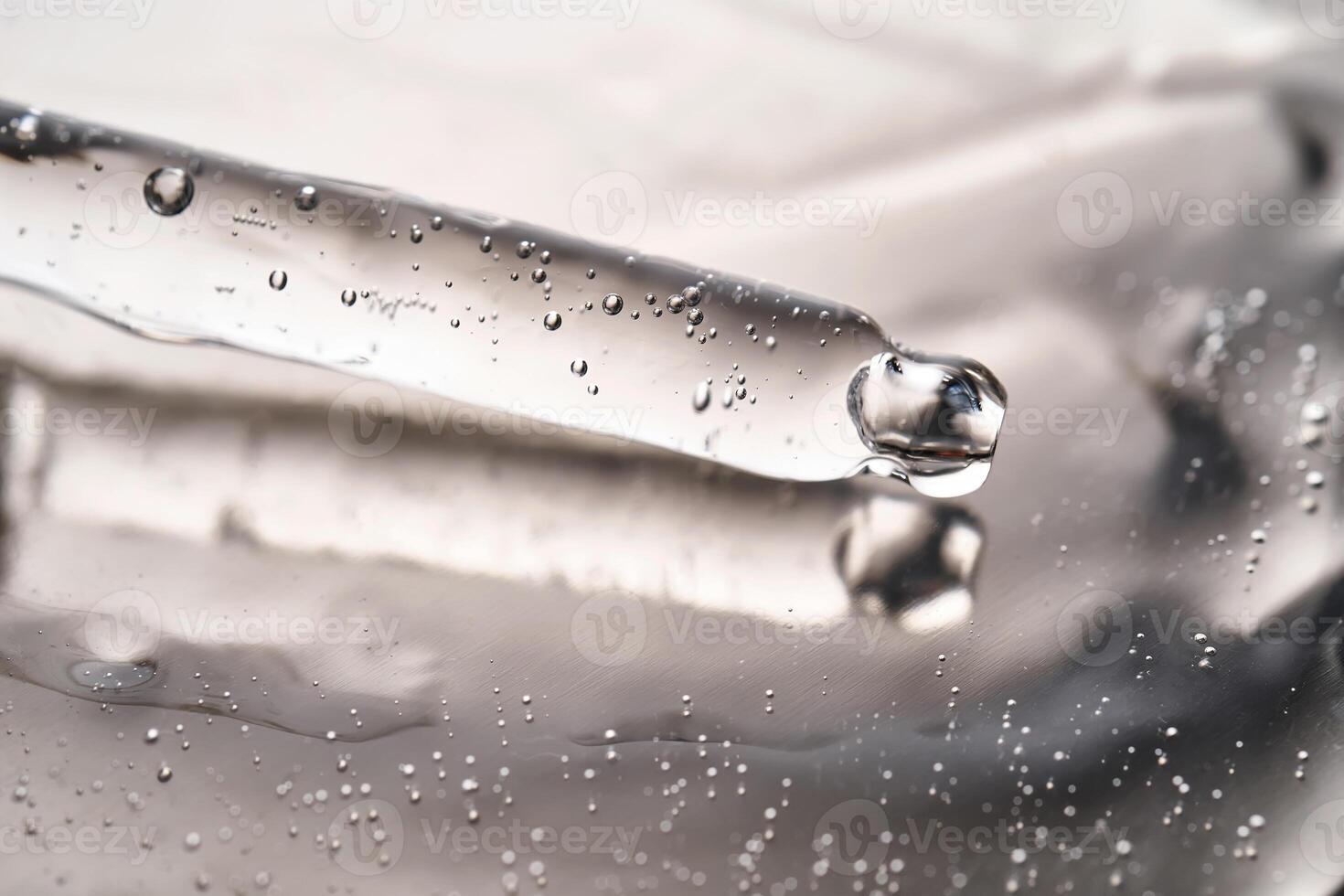 Dropper pipette with delicious serum with bubbles on the gel texture. photo