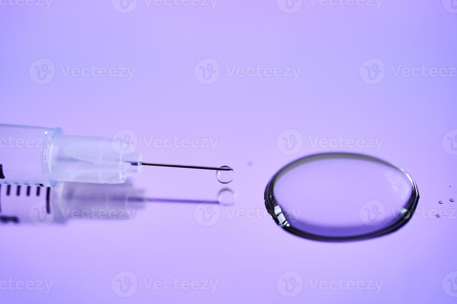 Injection syringe on a medical tray in bright violet color. photo