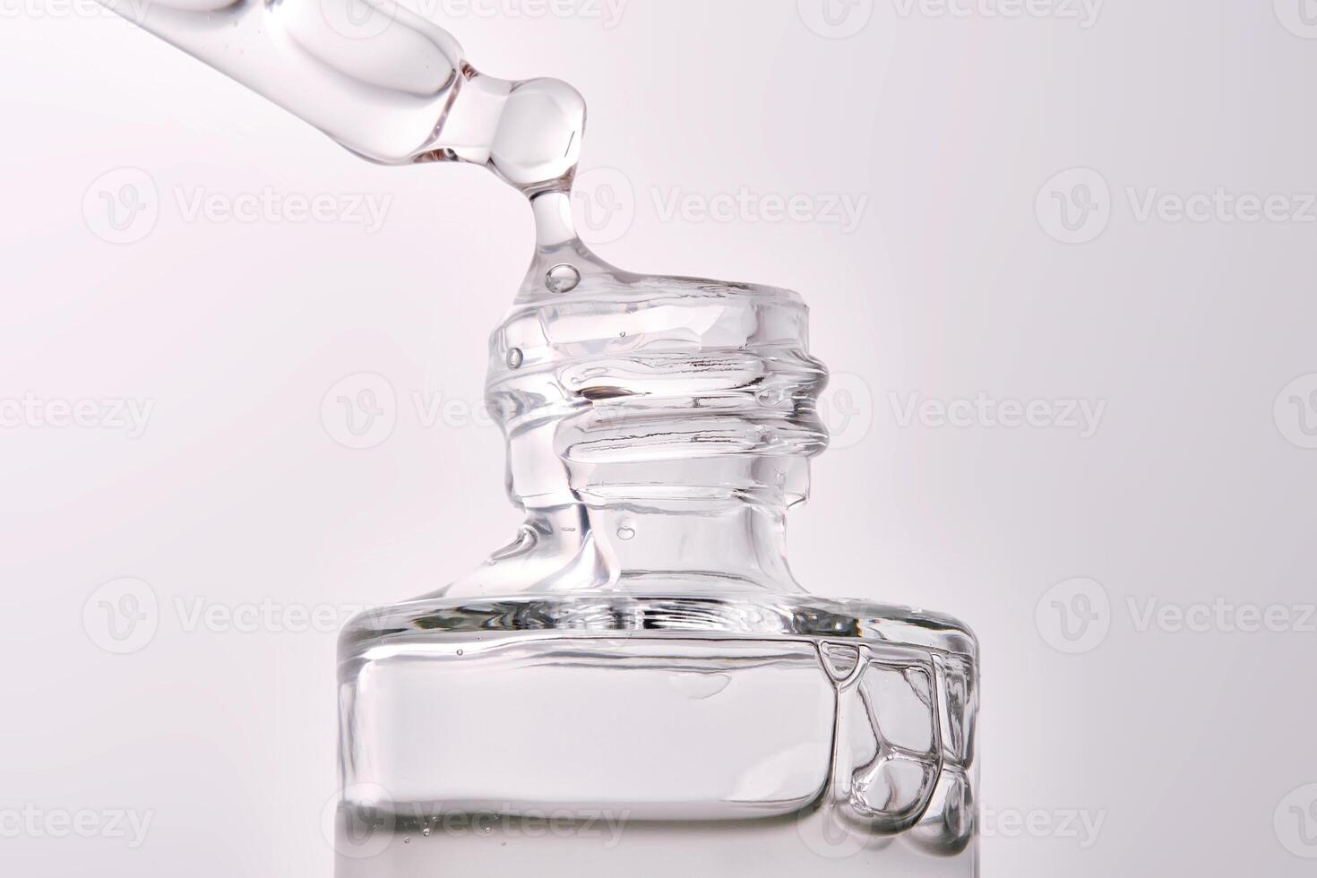 Close-up of a cosmetic bottle with a pipette showing the texture of the serum. photo