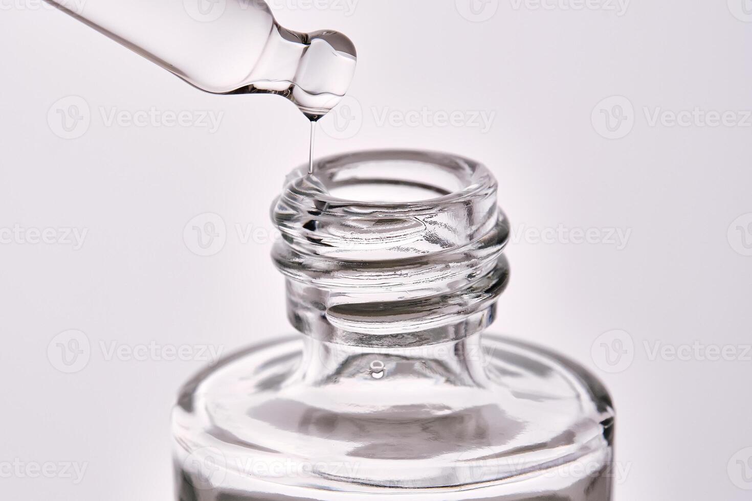 Close-up of a cosmetic bottle with a pipette showing the texture of the serum. photo