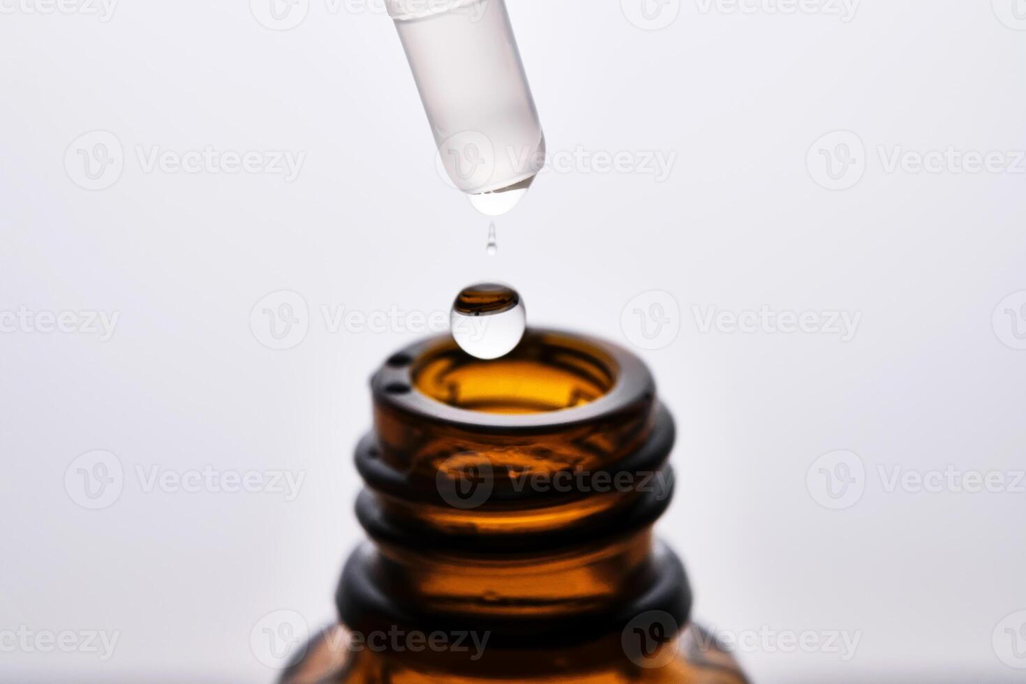 Close-up of a brown cosmetic bottle with a pipette. photo