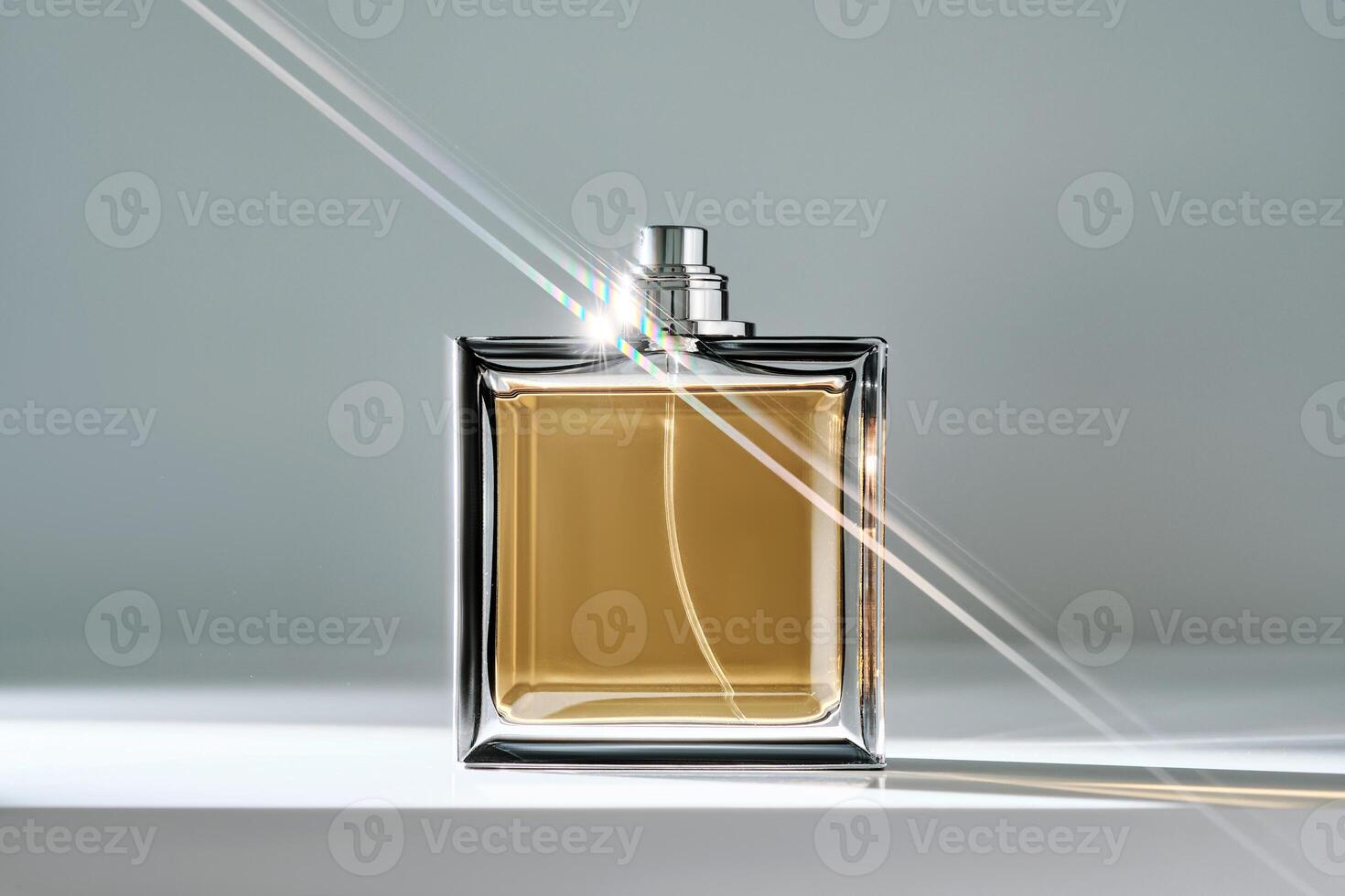A bottle of yellow perfume with a beautiful highlight. photo