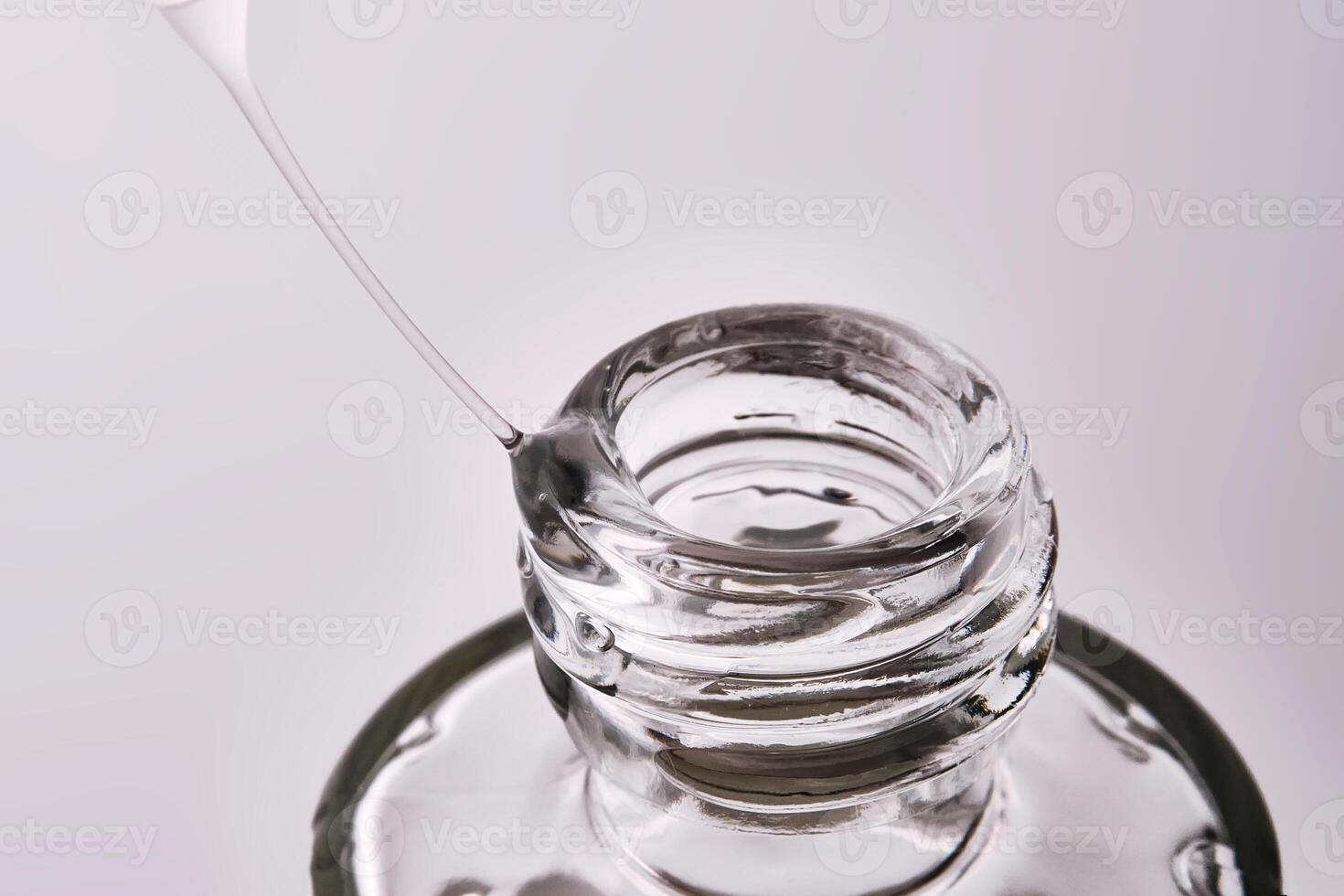Close-up of a cosmetic bottle with a pipette showing the texture of the serum. photo