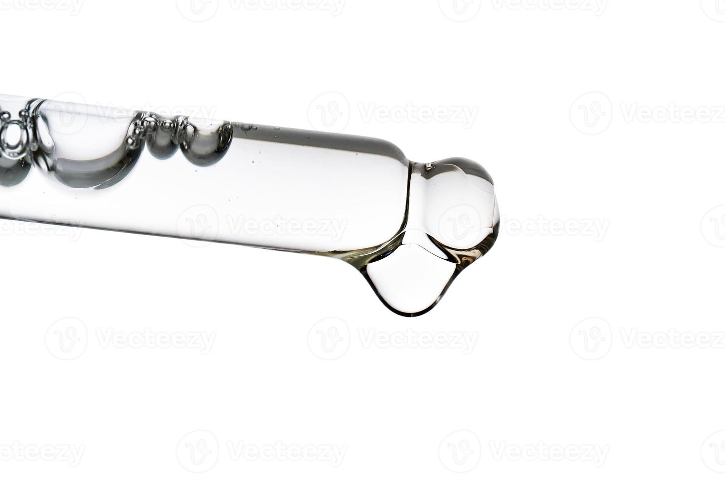 Dropper pipette with delicious serum with bubbles close-up. photo