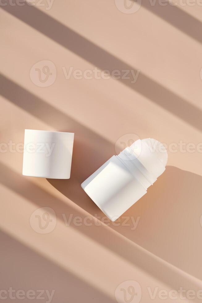 Roll-on deodorant on a purple background with shadow stripes. photo