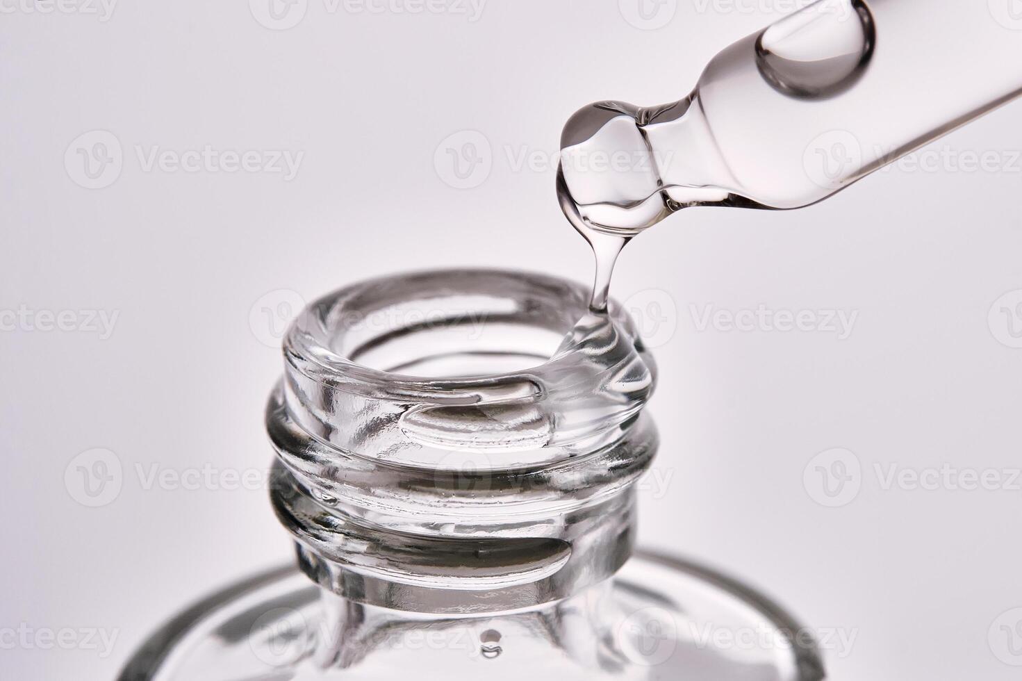 Close-up of a cosmetic bottle with a pipette showing the texture of the serum. photo