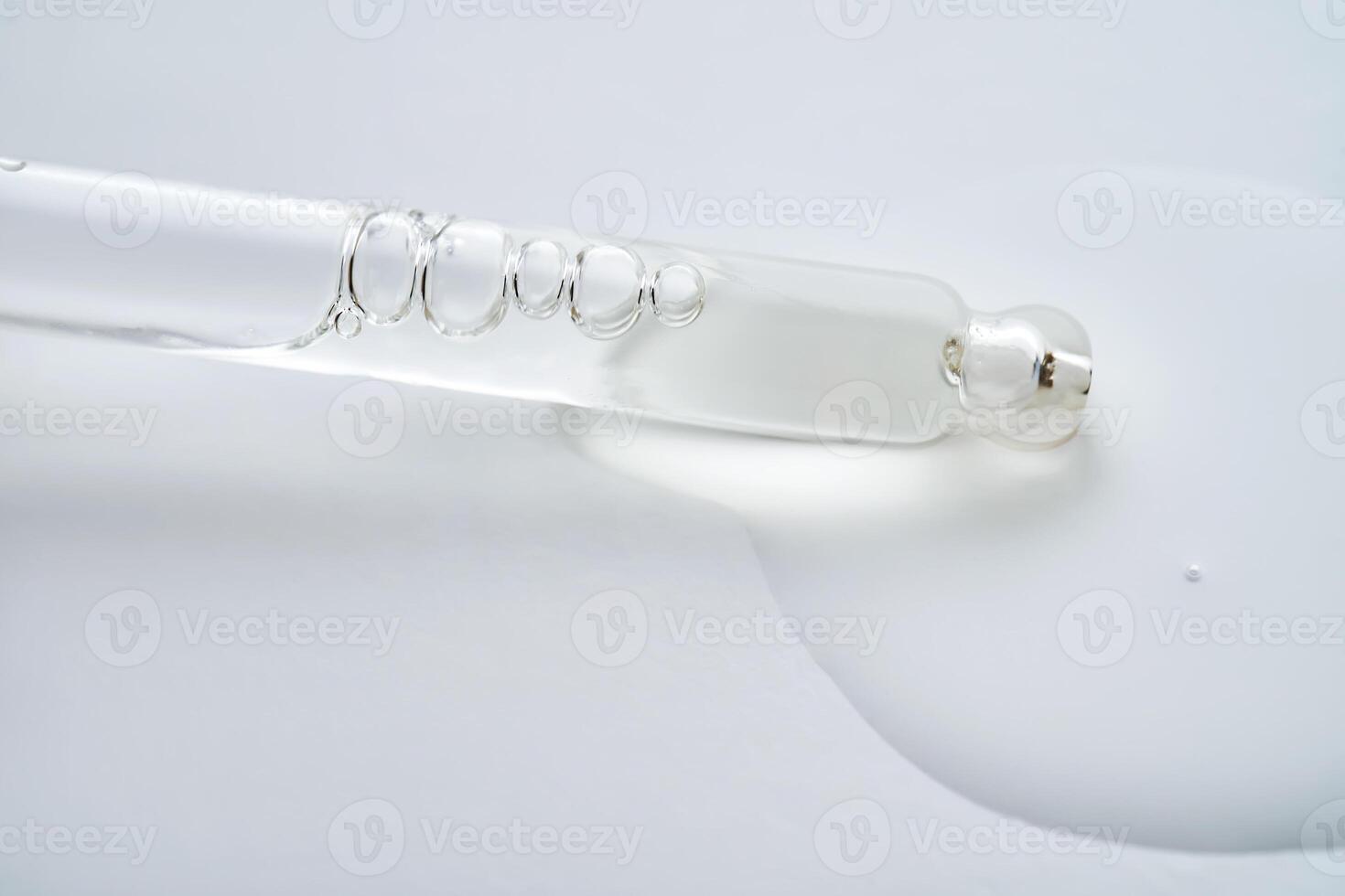 Dropper pipette with delicious serum with drop close-up. photo