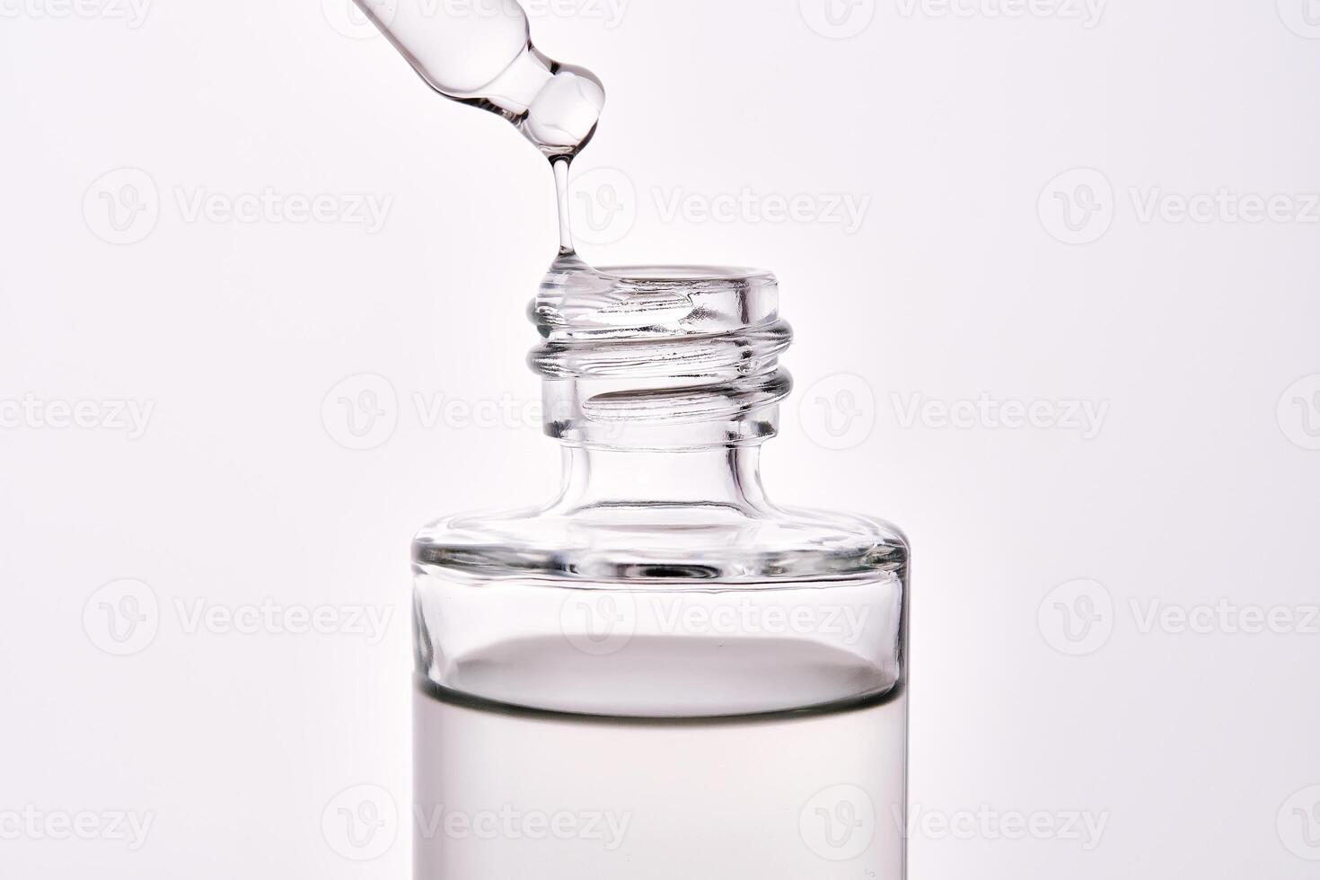 Close-up of a cosmetic bottle with a pipette showing the texture of the serum. photo