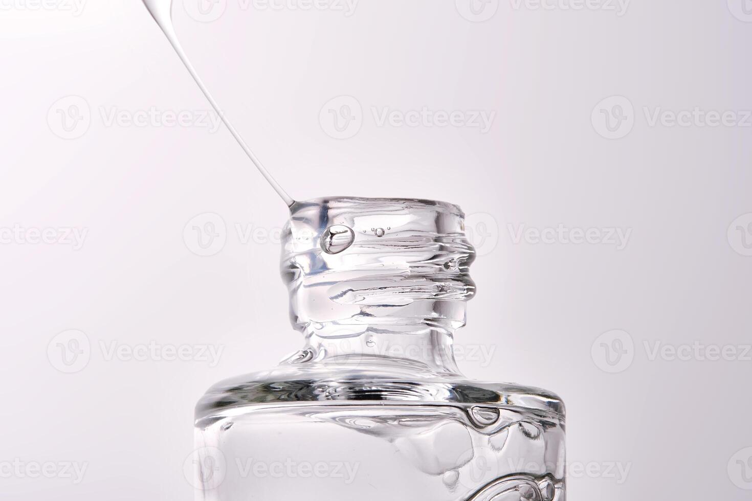 Close-up of a cosmetic bottle with a pipette showing the texture of the serum. photo