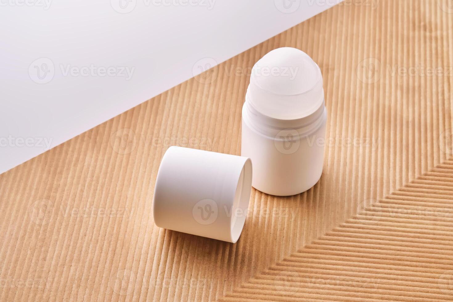 Roll-on deodorant on a background with beige grooves. photo