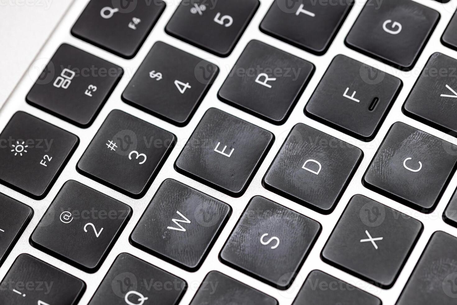 keyboard of famous silver colored laptop with fingerprints photo
