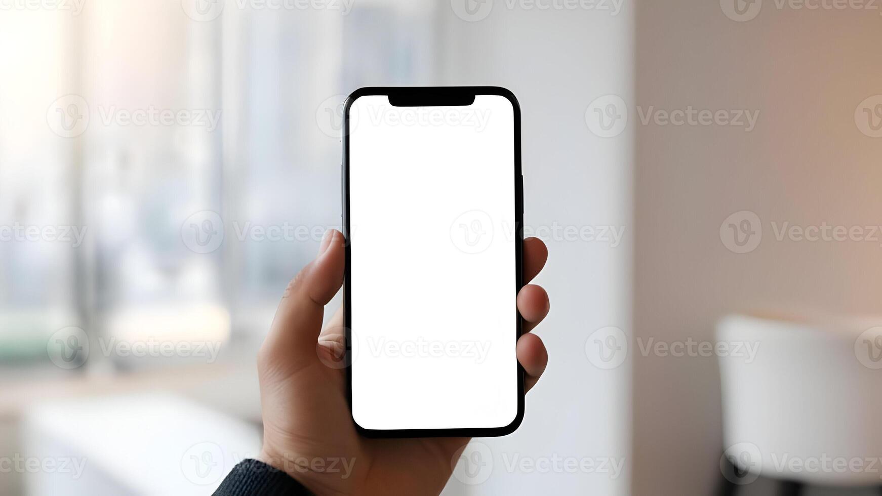Hand holding smartphone with blank white screen with blurred background. photo