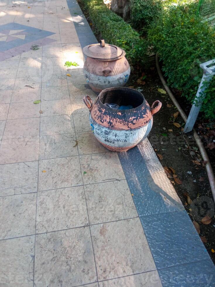 a trash can made of tires placed in a city park. the concept of maintaining environmental cleanliness photo