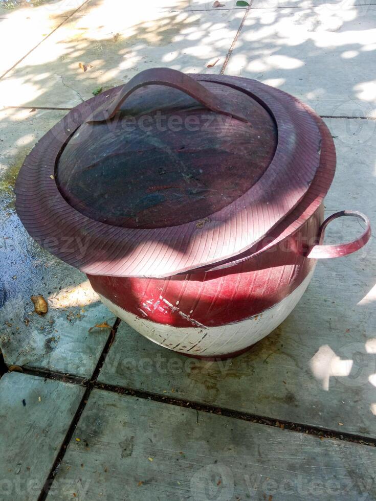 a trash can made of tires placed in a city park. the concept of maintaining environmental cleanliness photo
