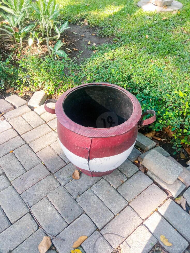 a trash can made of tires placed in a city park. the concept of maintaining environmental cleanliness photo