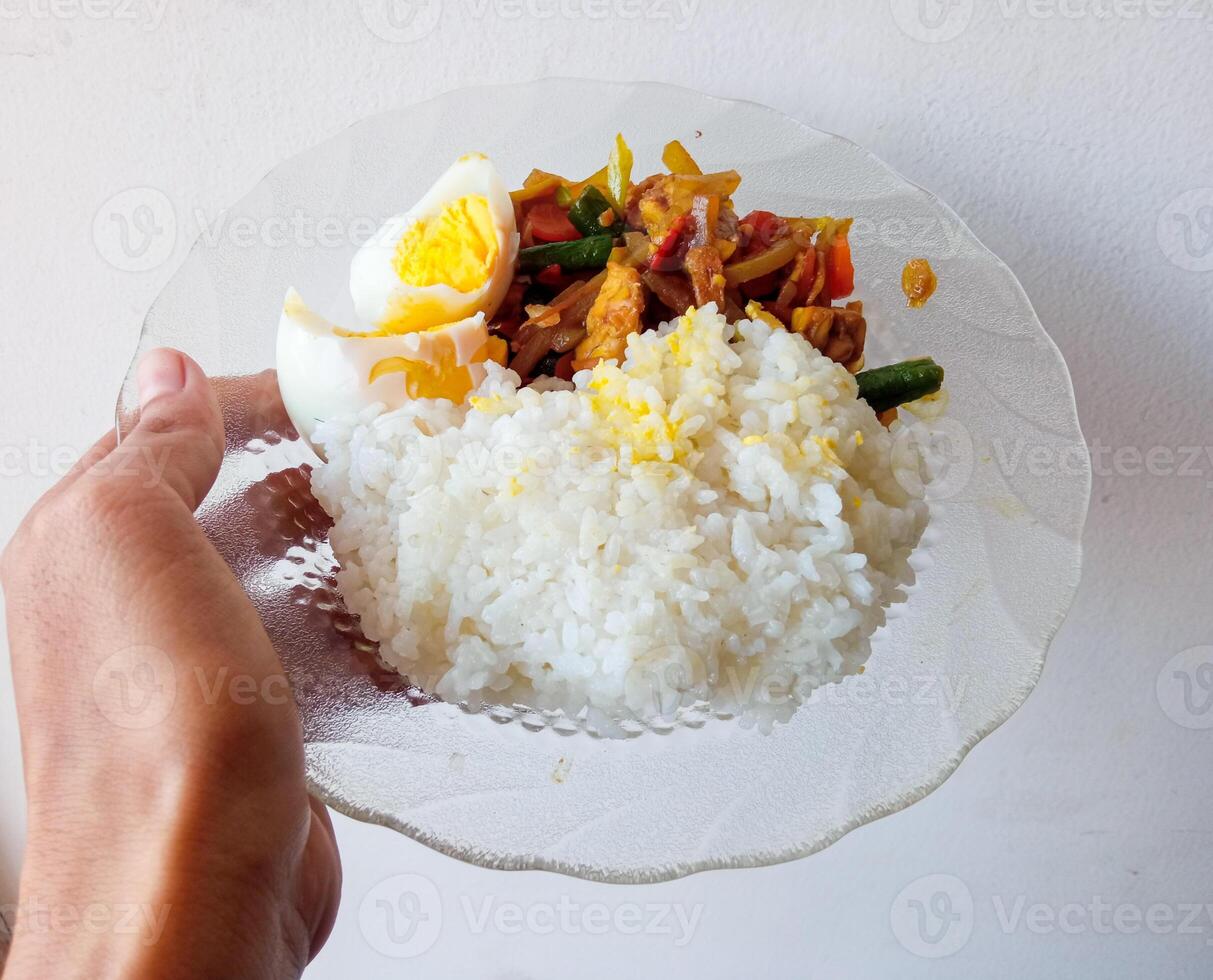 a plate of rice, boiled eggs and side dishes of vegetables to gain weight. isolate on white photo