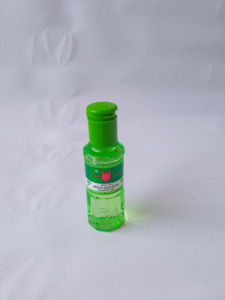 Surabaya, Indonesia - 19 October 2024 Cap lang. Eucalyptus oil. Cajuput oil. Helps relieve stomach aches, flatulence, nausea, and itching due to insect or mosquito bites. isolate on white photo
