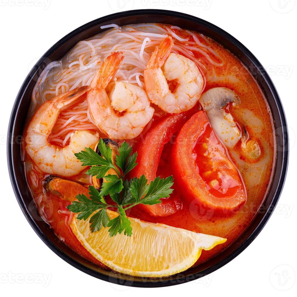 Thai food Tom Yum Kung.Thai hot and spicy soup shrimp in bowl.with Straw Mushroom,lime,Kaffir lime leaves,tomato and chilli. Splash on the air. isolated on white background. photo