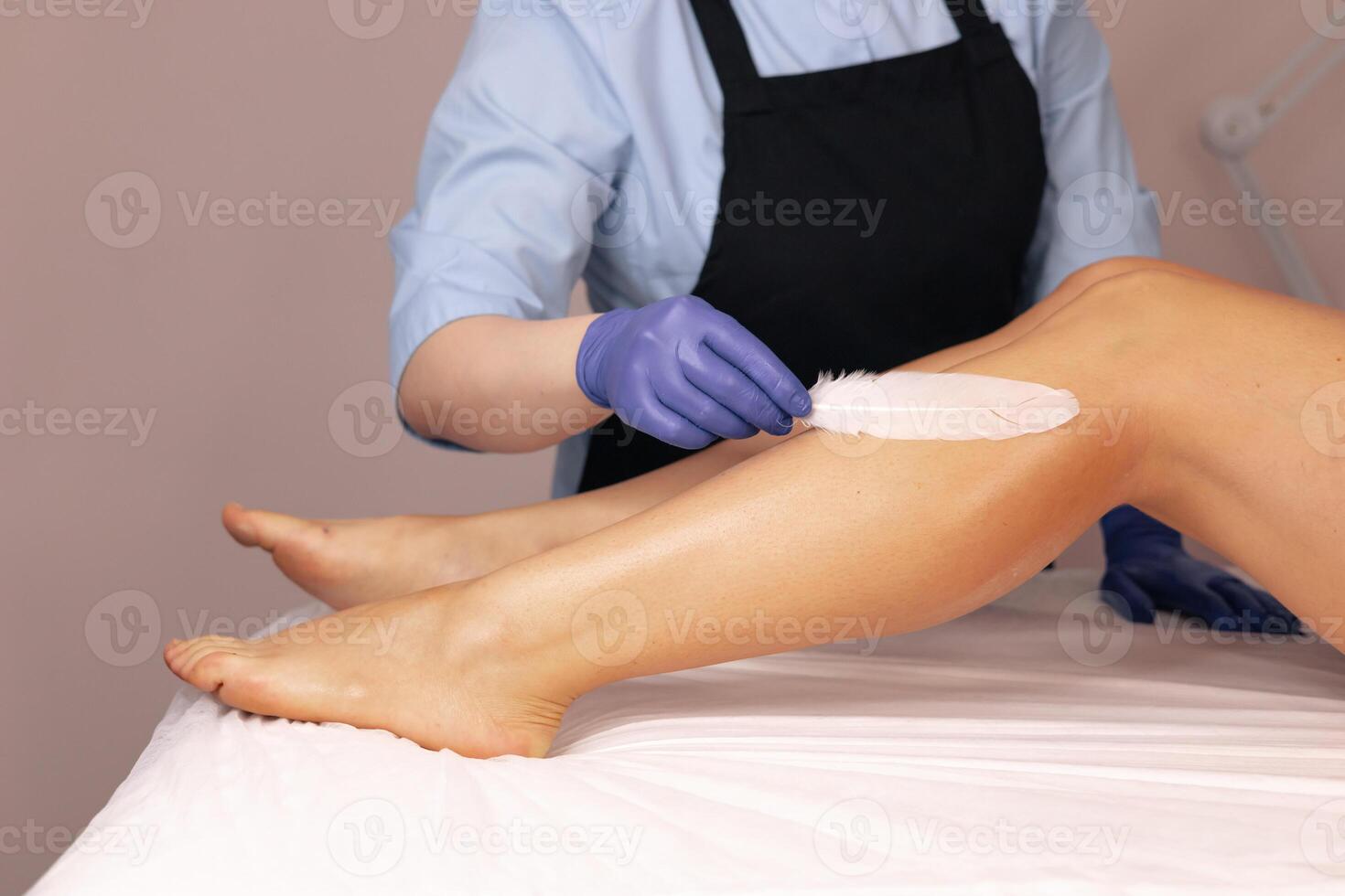 Aesthetic leg waxing process with gentle techniques in a tranquil beauty salon setting photo