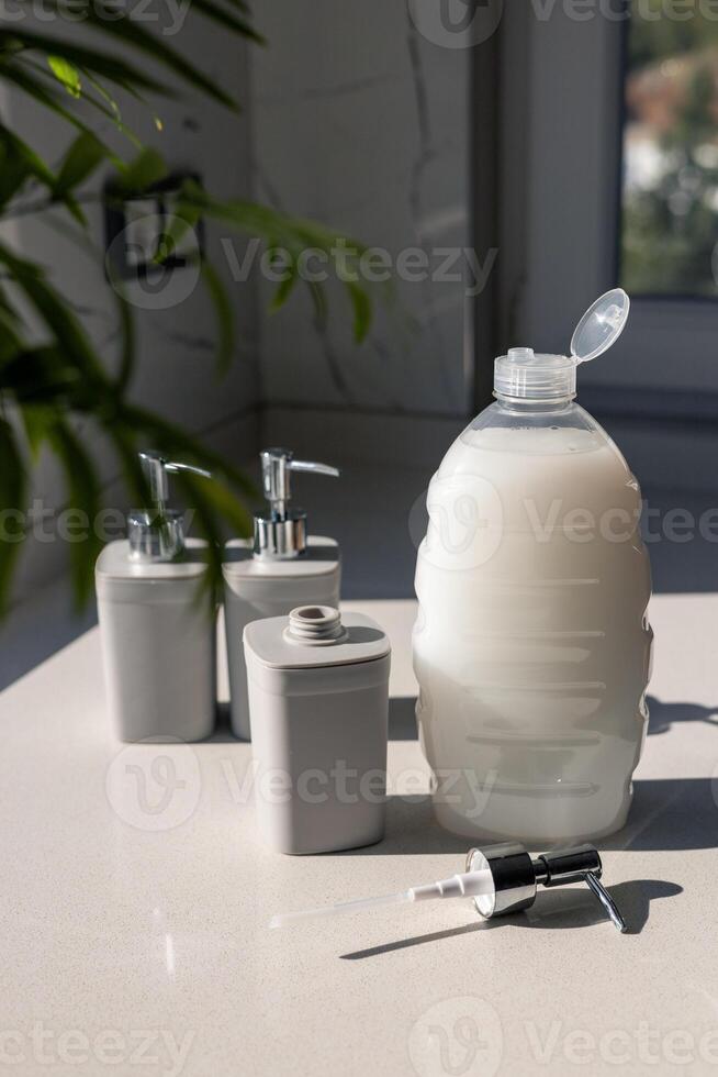 Various gray cosmetic containers arranged on a bright countertop in natural light photo