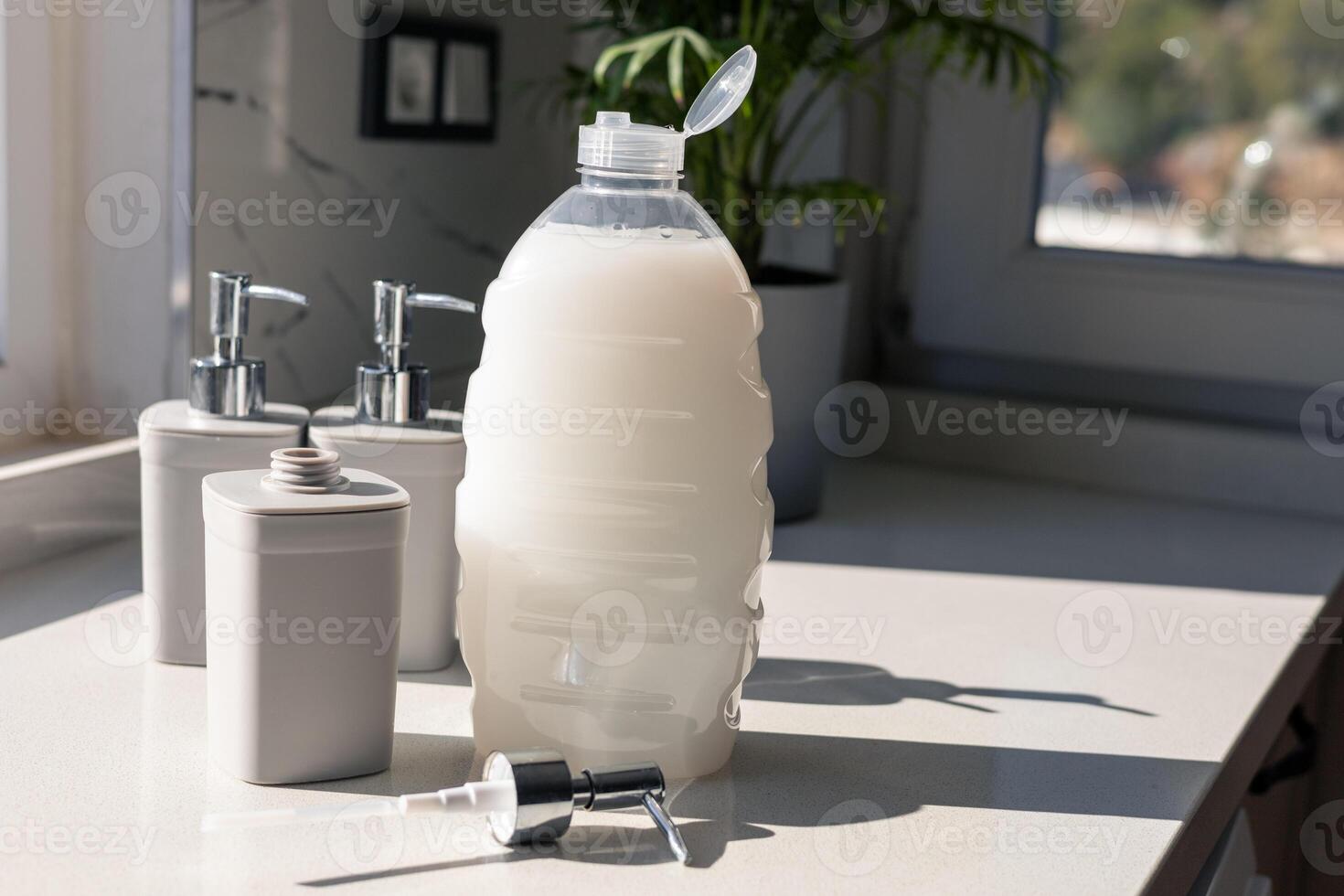 Various gray cosmetic containers arranged on a bright countertop in natural light photo