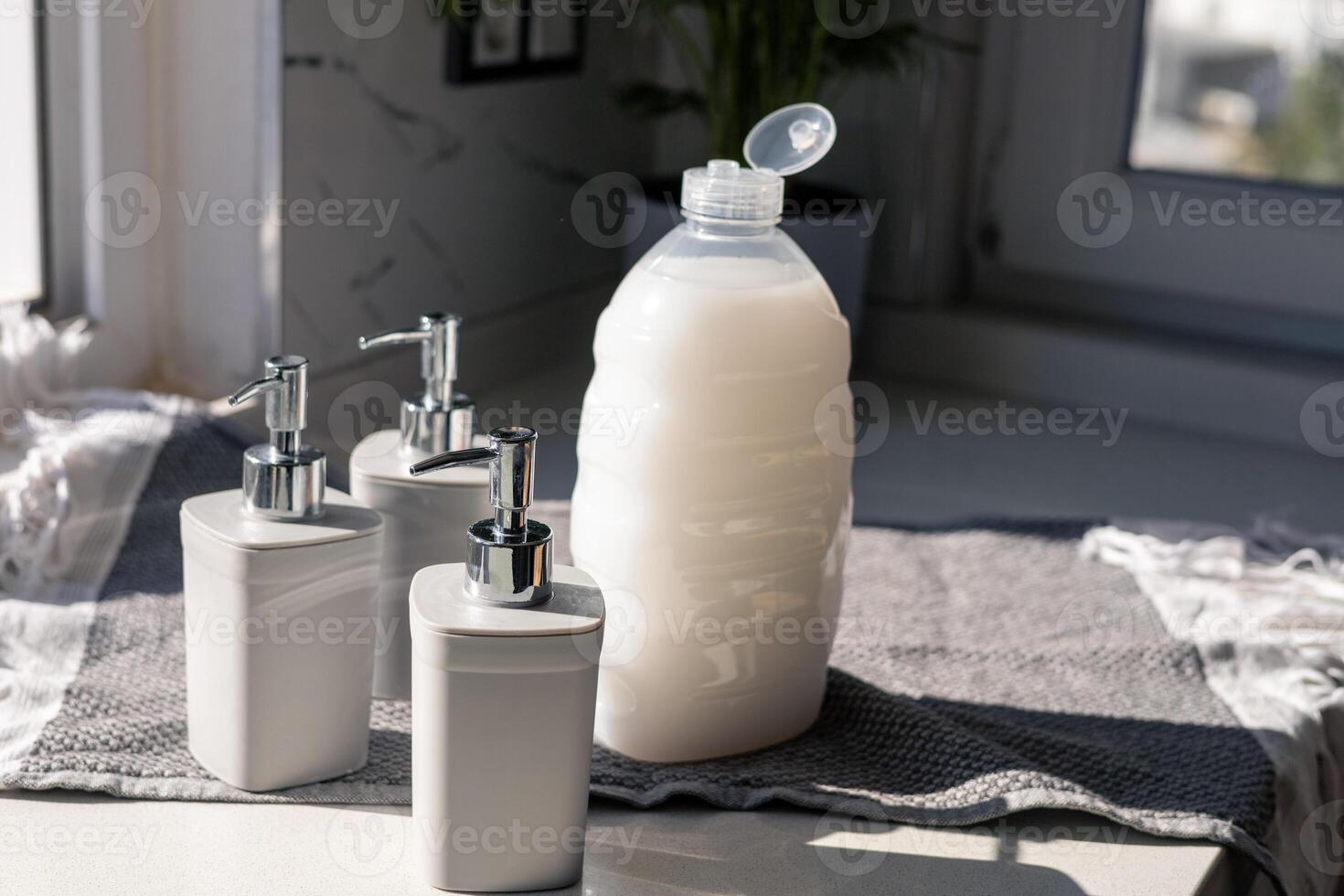 Various gray cosmetic containers arranged on a bright countertop in natural light photo