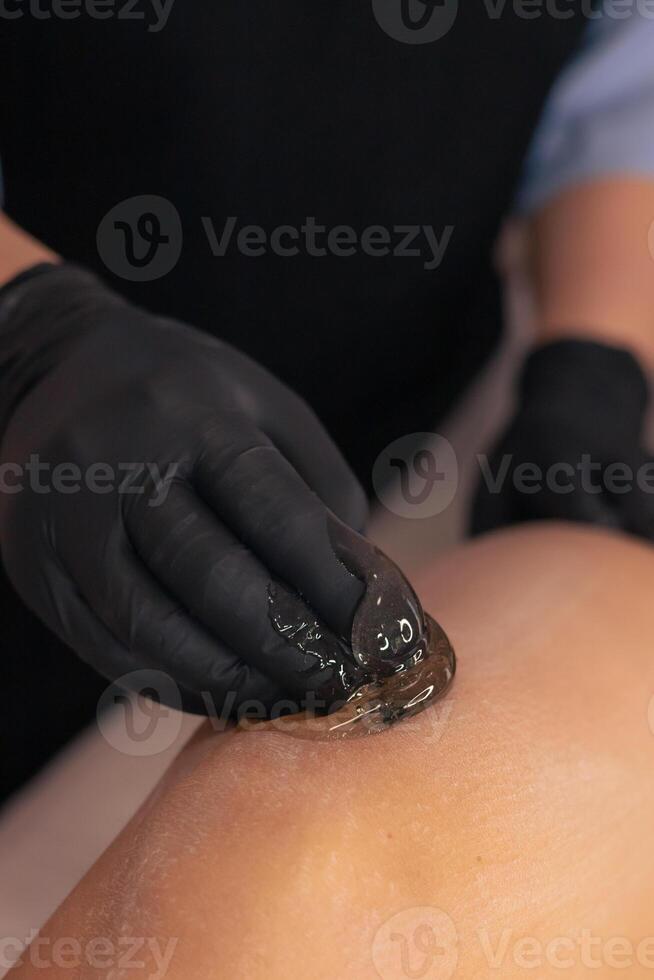 Professional waxing treatment in a serene spa environment during a relaxing session photo