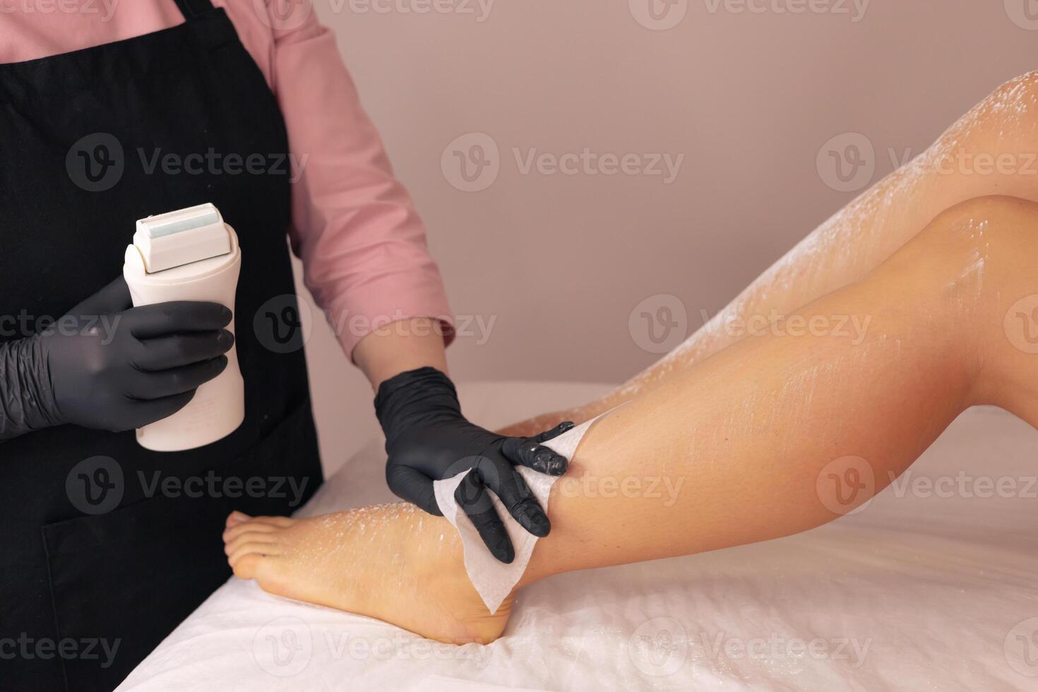 Aesthetic leg waxing procedure in a serene salon setting with expert attention to detail photo