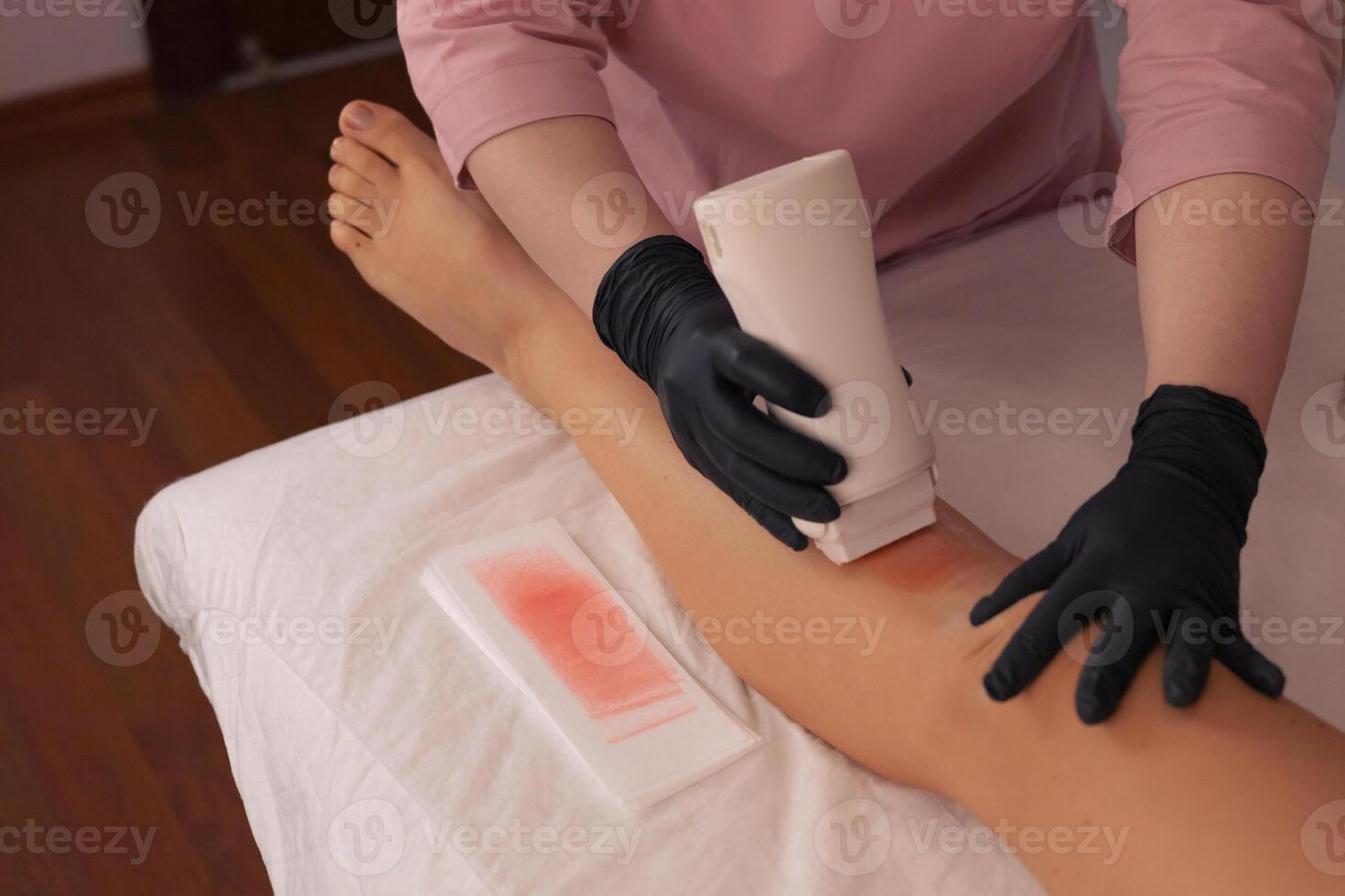 Aesthetic waxing technique being applied in a beauty salon during a personal care treatment photo