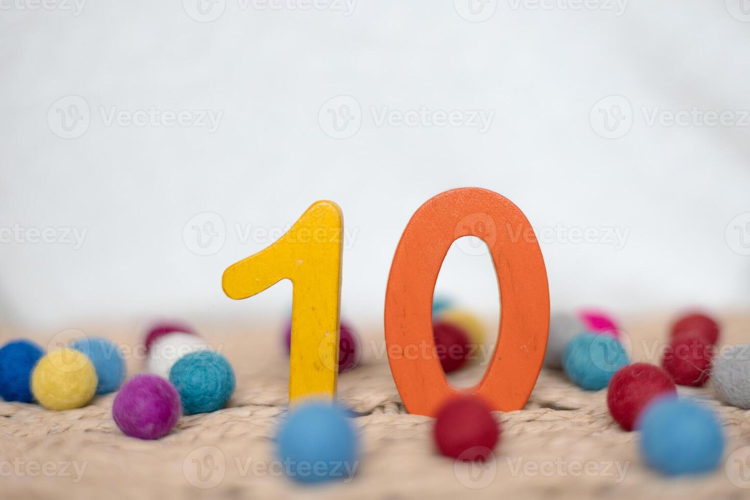 Close-up wooden figure number ten on a white blurred background photo