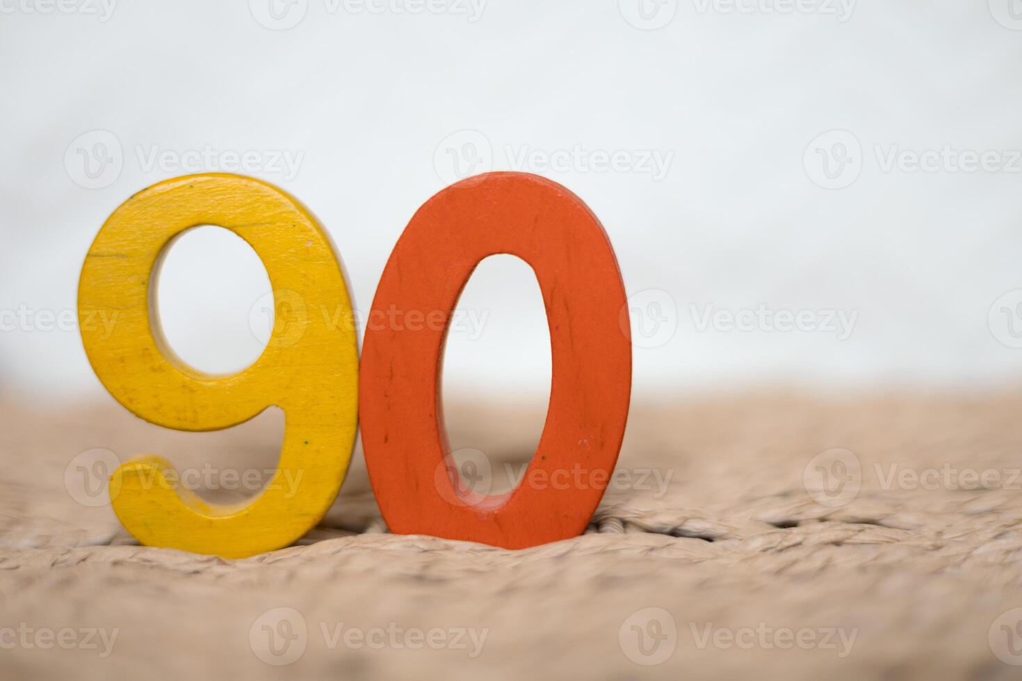 Close-up wooden figure number ninety on a white blurred background photo
