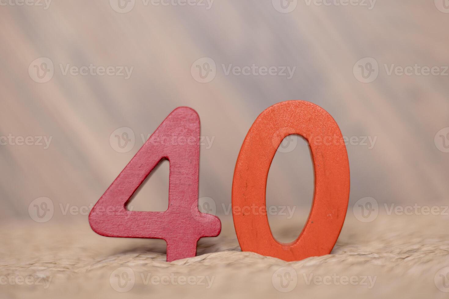 Close-up wooden figure number fourty on a beige blurred background photo