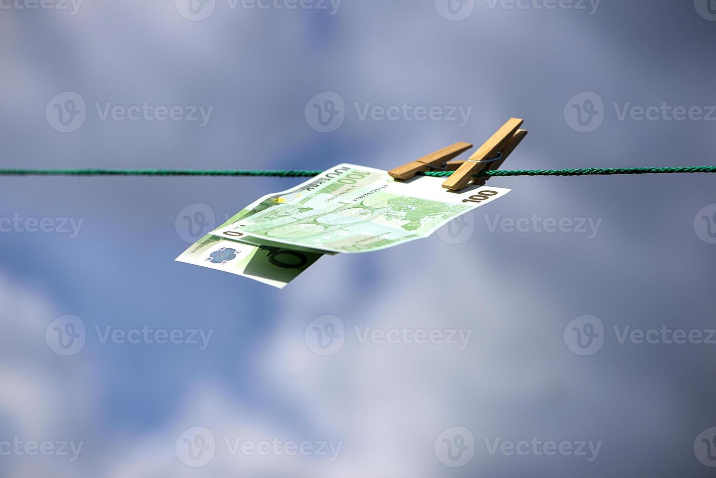 paper money bills flutter in the wind against a blue sky background photo