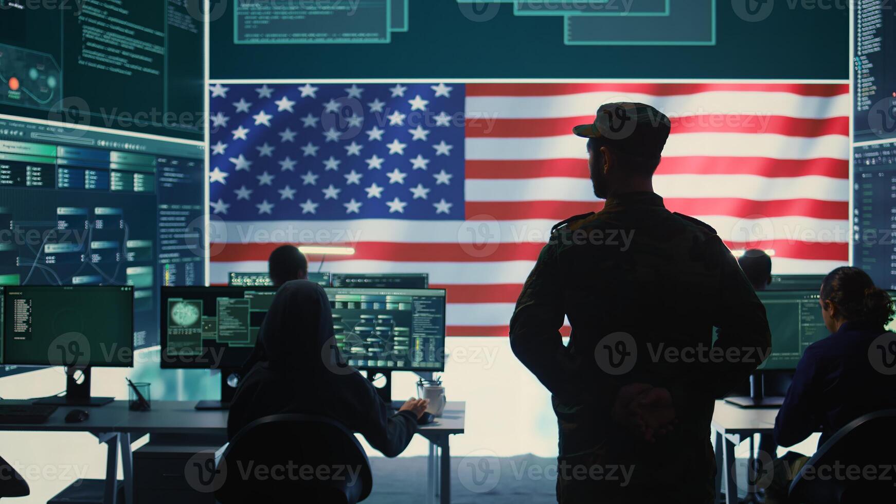 American military personnel ensuring servers protection and classified information, protecting state secrets in high tech agency office. Army soldier supervises hacking activity. Camera B. photo