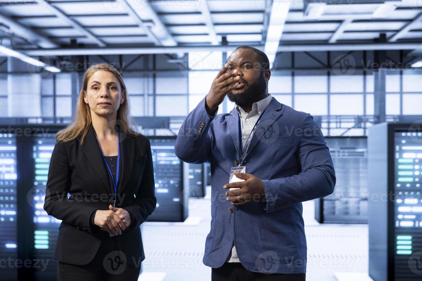 Team of technicians in data center with advanced technology, ensuring cybersecurity and efficient network management. Teamworking colleagues in server hub optimizing data center infrastructure photo