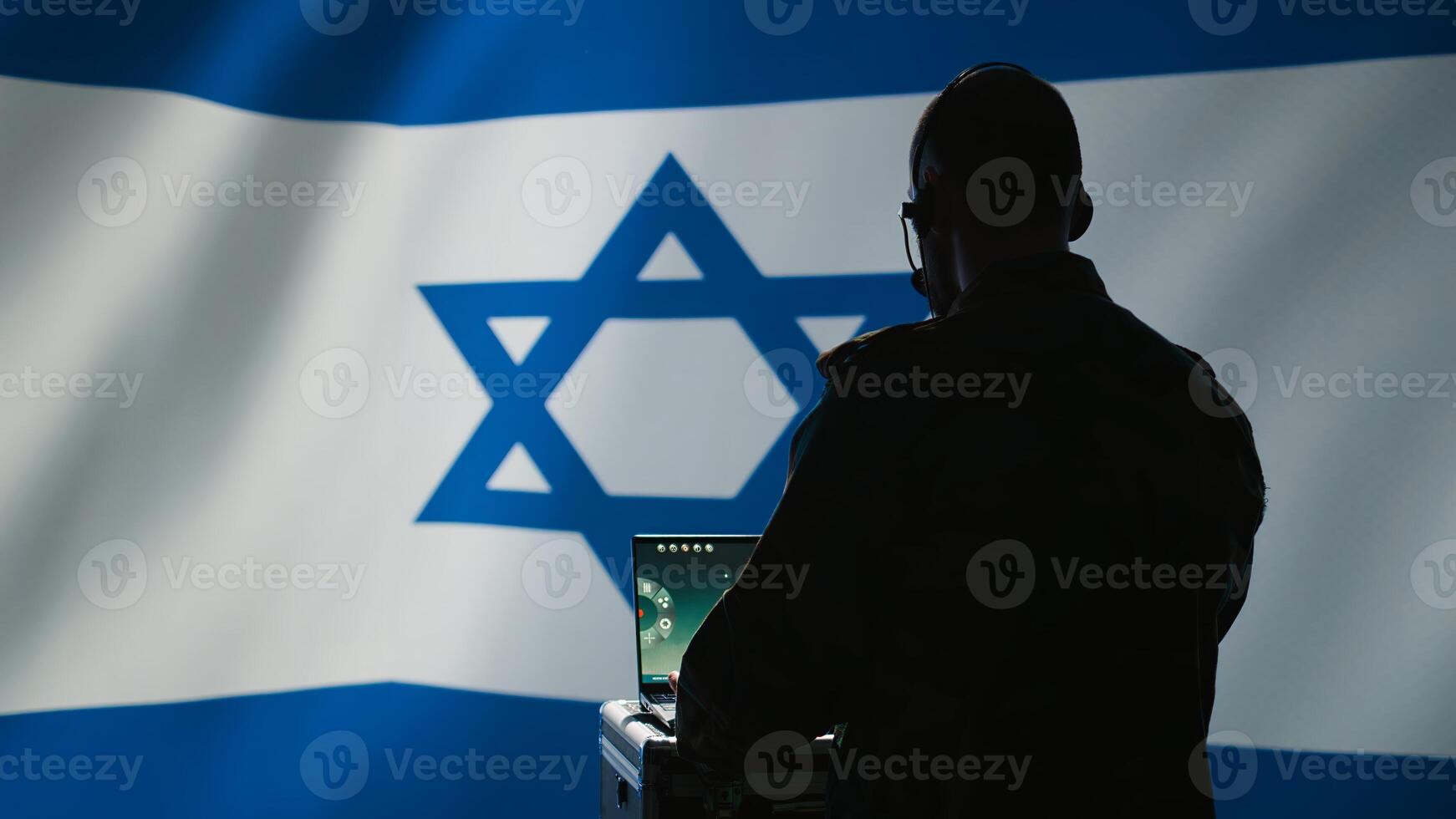 Israeli air defense command operator conscript using radar system on laptop to detect incoming ballistic missiles. IDF army soldier scanning rockets approaching borders, deploying shields, camera B photo