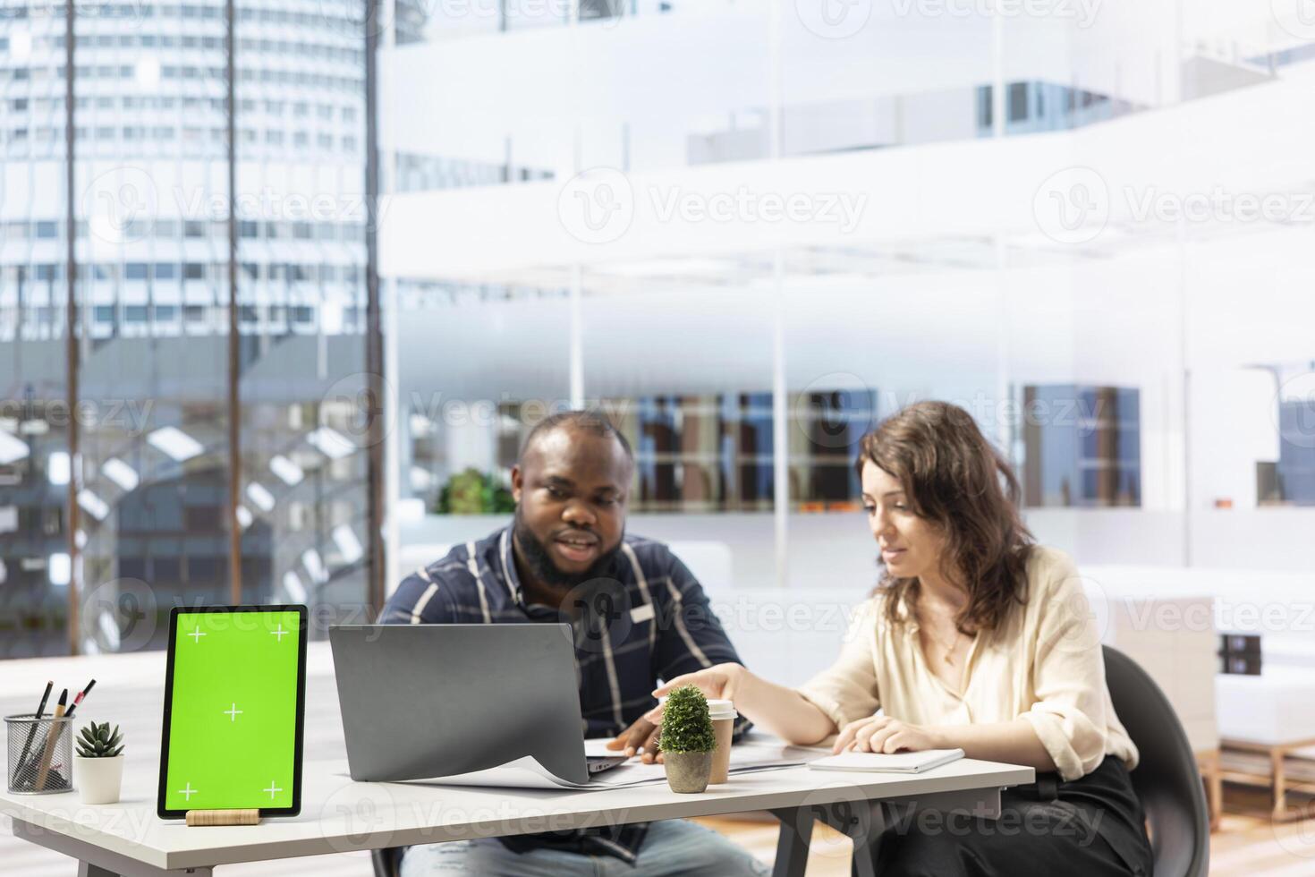 Real estate agent presenting renting opportunity to client next to copy space on tablet, securing a contract with female entrepreneur for business relocation office space. Workspace design. photo
