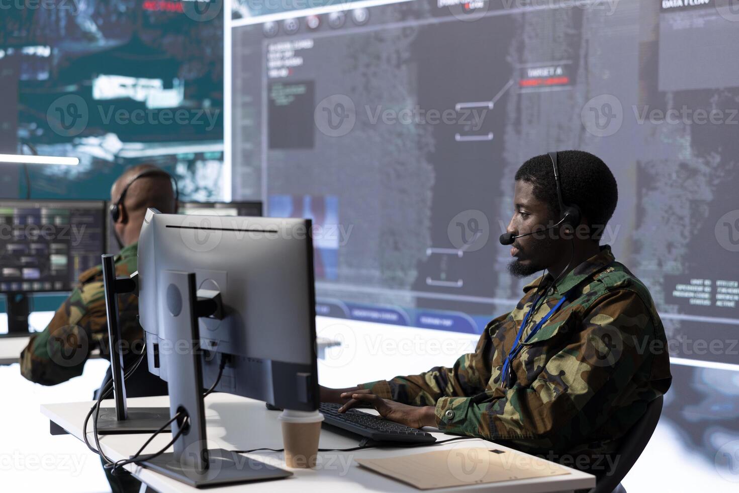 Military intelligence expert in a modern control room handles surveillance operations, analyzing real time satellite data and transmitting security measures to protect national interests. photo