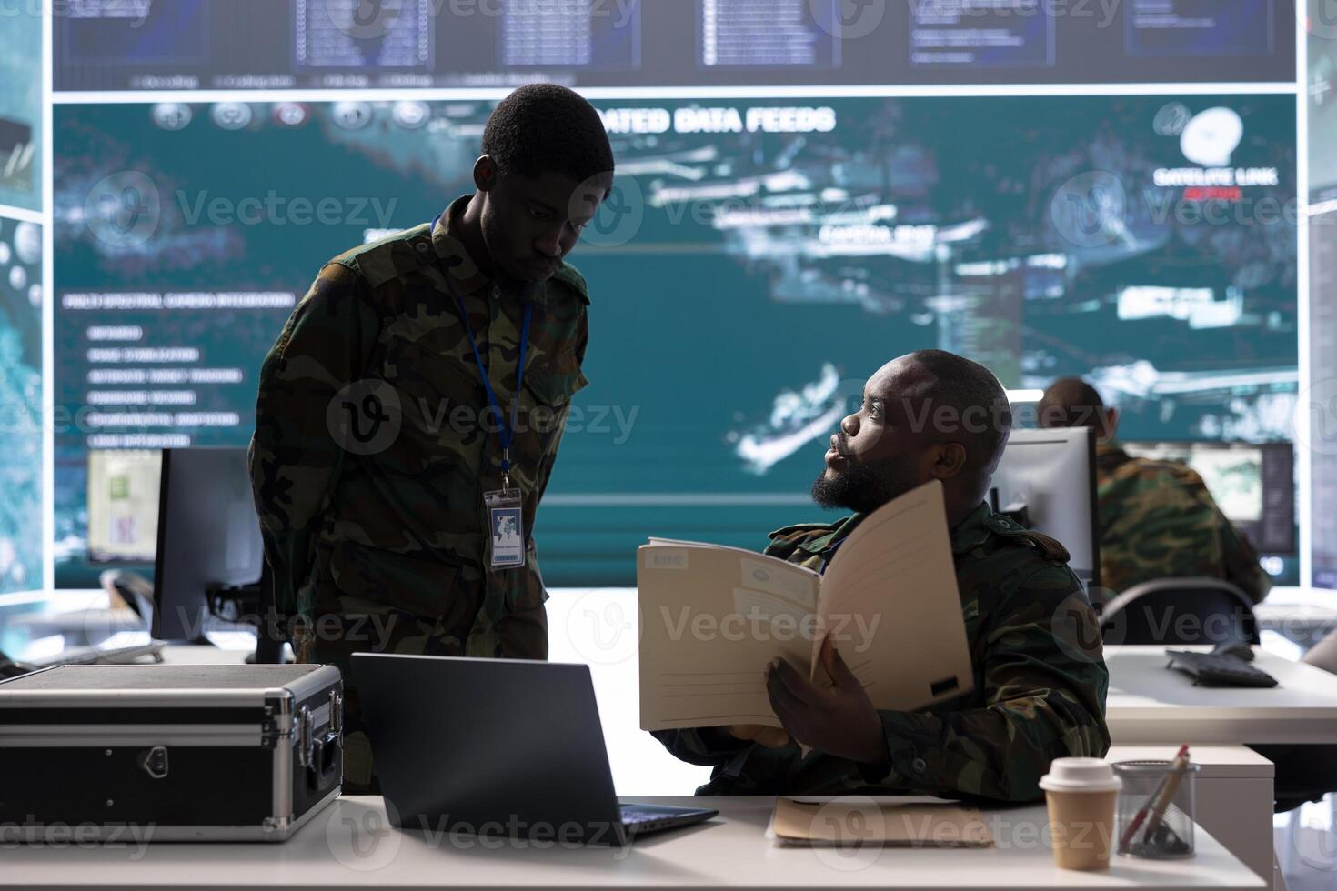 Military experts in an operations center handle satellite data details, overseeing live surveillance for reconnaissance activity. Intelligence operations to support strategic military missions. photo