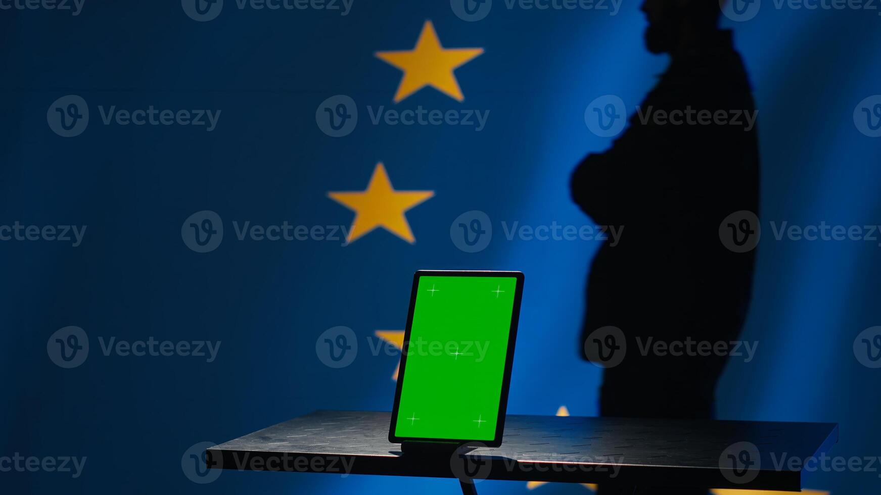 European Union counterintelligence division uses green screen tablet to protect against propaganda affecting elections. EU security service safeguarding democracy online using mockup device, camera A photo