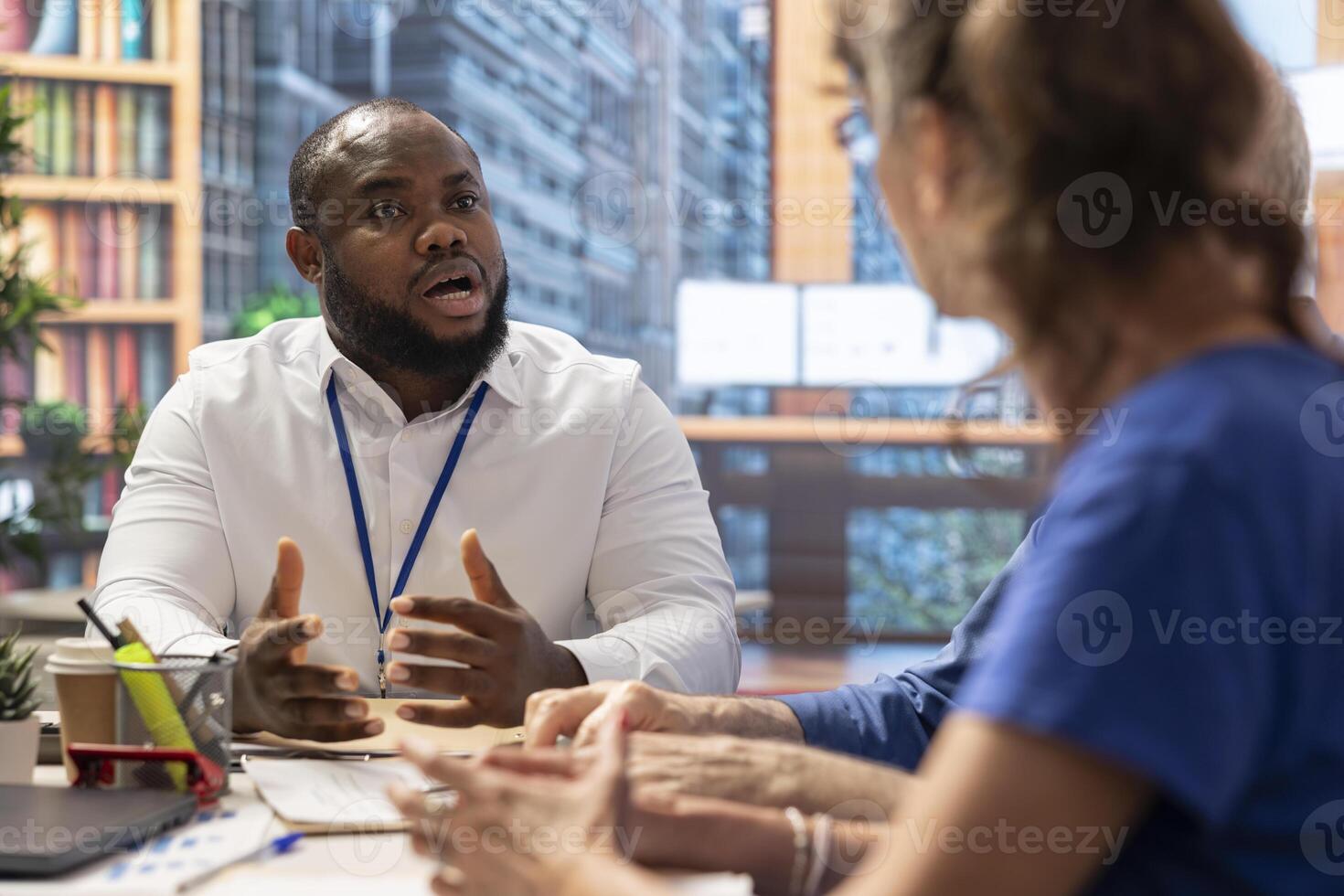 Elderly couple meeting with financial expert to explore various retirement options and secure their financial future. Detailed consultation with an advisor about life savings and pension. photo