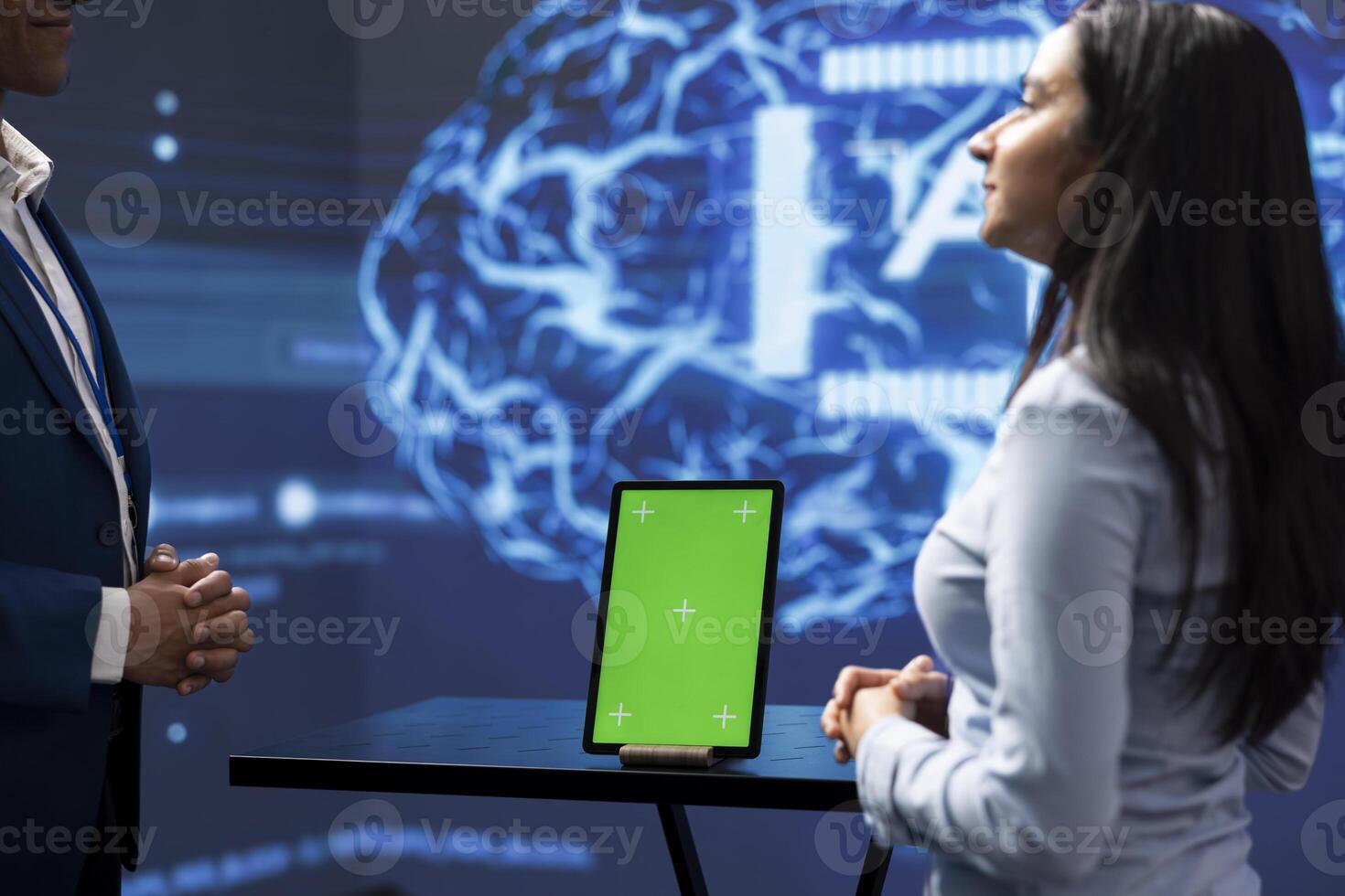 Teamworking colleagues in startup doing advancements in AI field using chroma key tablet. Mockup device used by programming team coworkers working in high tech lab featuring artificial intelligence photo